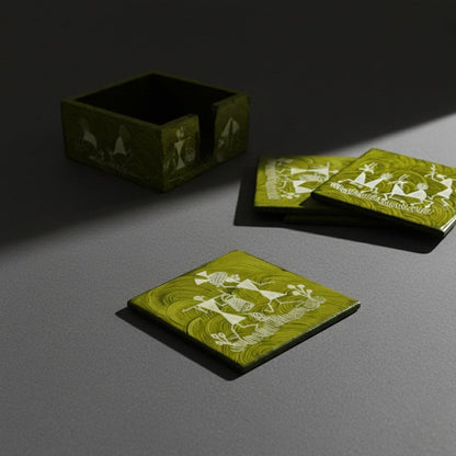 Green coasters with white warli designs on a gray surface