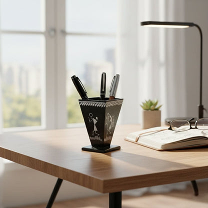 Desk setup with a pen holder, books, and glasses in a bright room.