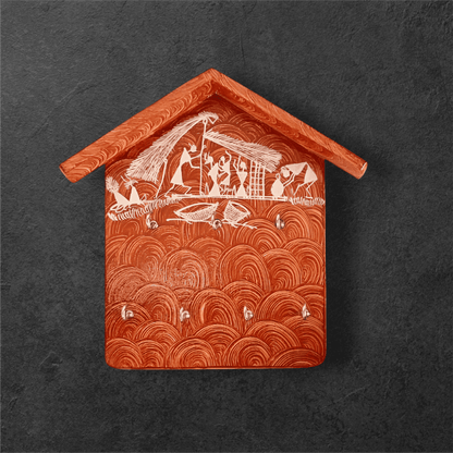 A handcrafted wooden key holder in the shape of a house with Warli art, primarily green with white patterns.