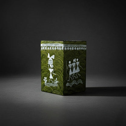 Decorative box with green and white design on a dark background
