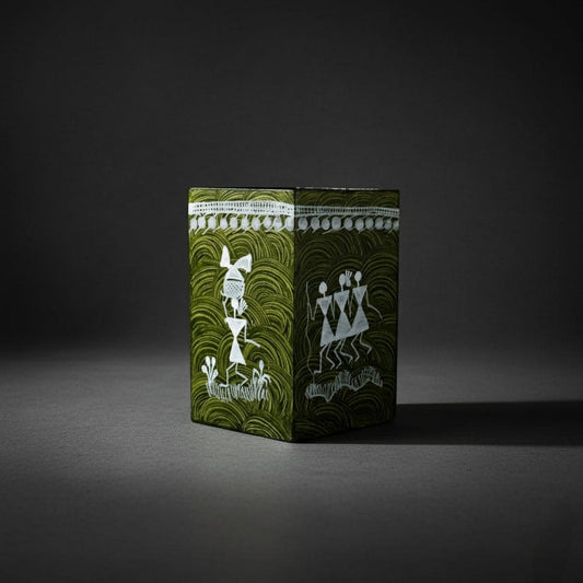 Decorative box with green and white design on a dark background