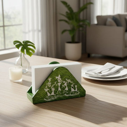 A triangular wooden napkin holder with Warli tribal artwork, predominantly green with white patterns